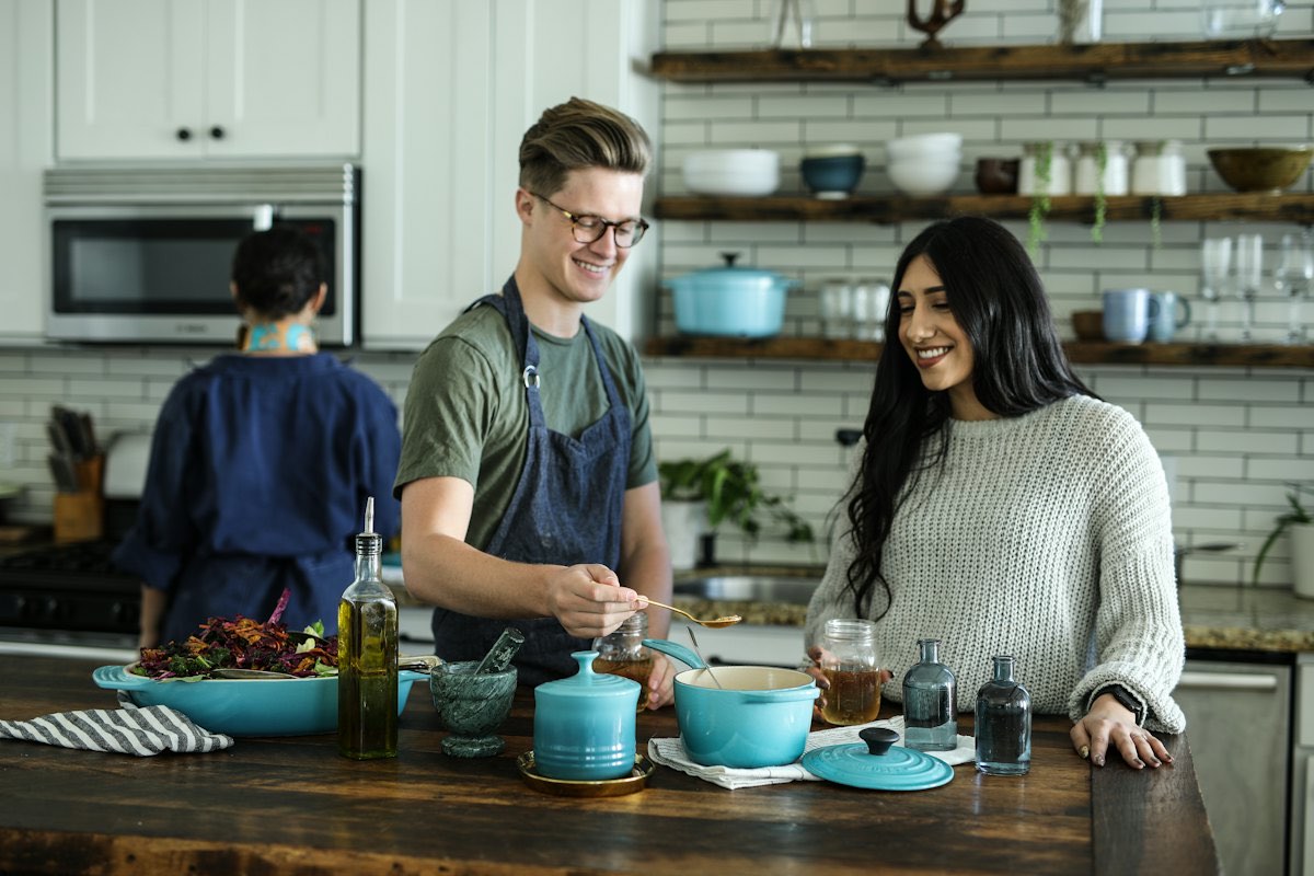 Two people cooking a meal together in a home kitchen